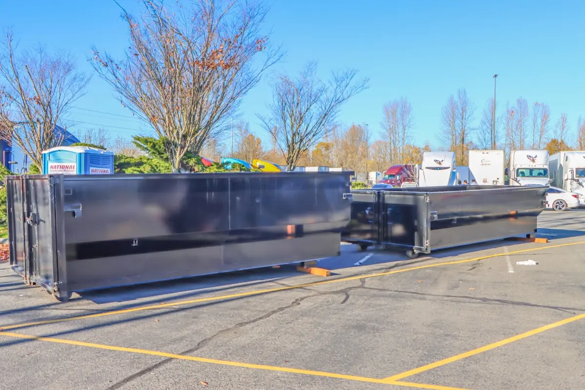 Professional dumpster rental service with roll-off container on residential driveway in Spring Lake Park